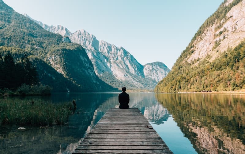 Person practicing mindfulness outdoors as part of a personal growth journey